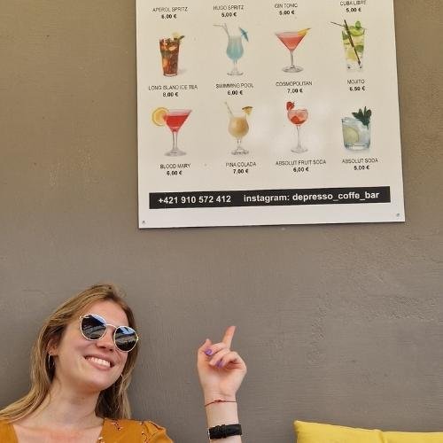Girl pointing her finger to cheap cocktails at Depresso Coffee Bar in Bratislava